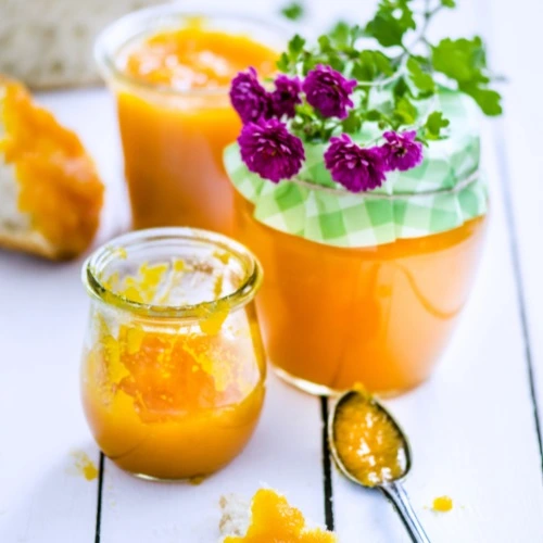 Pumpkin jam with flowers and bread