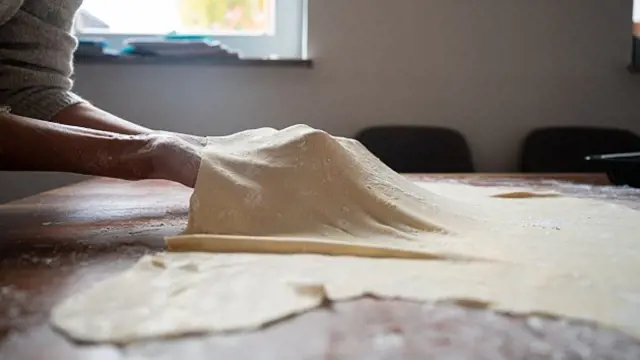 Dough being stretched on table