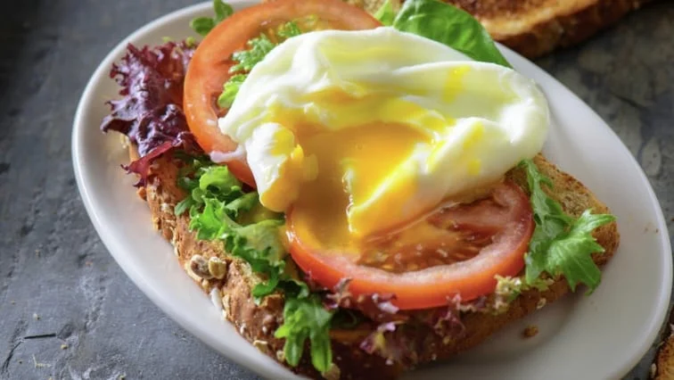 Poached egg on toast with tomato and lettuce