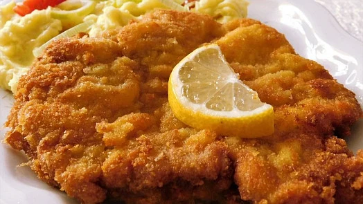 Breaded pork cutlet with lemon slice and mashed potatoes