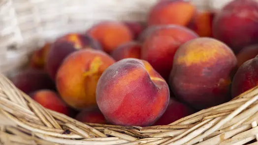 Fresh peaches in basket