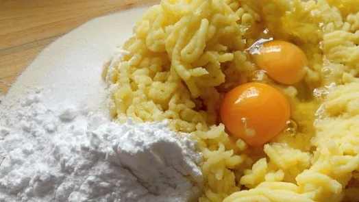 Suroviny na knedlíky: bramborová těsto s vejci a moukou.
